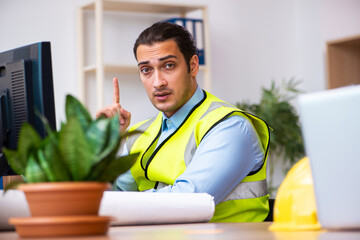 Young male architect working in the office