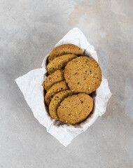 Walnut cookies with matcha tea in a box on a light gray background top view