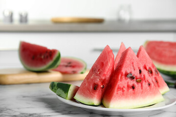 Yummy watermelon slices on white marble table in kitchen