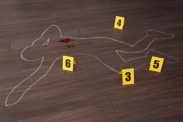 Crime scene with chalk outline of human body, blood, bullet shells and evidence markers on wooden floor. Detective investigation