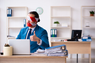 Mouth and eyes closed male employee working in the office