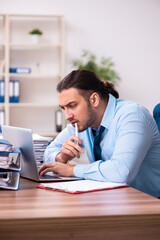 Young male businessman employee working in the office