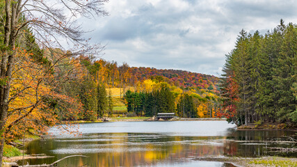 Autumn Lake with covered bridge