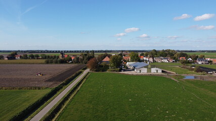 Fototapeta na wymiar A very small place Oudemolen in Brabant near Willemstad. With drone taken photo of a village with a mill and farmlands around it.