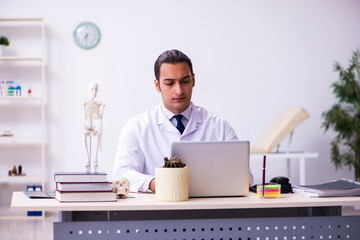 Young male doctor working in the clinic