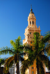 Fototapeta na wymiar The Freedom Tower in Miami Florida is surrounded by palm trees