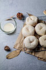 Fresh homemade sweet donuts with powdered sugar and dipping sauce with copy-space. Breakfast concept, Selective focus.