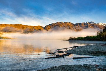 Wakapitu lakeside towards the Glenorchy with early morning cloud hovering above the lake at sunrise