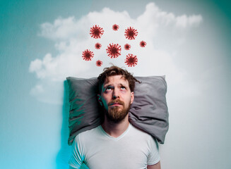 Coronavirus, covid-19 phobia, fear of pandemics. Man laying in bad and thinking about danger of a...