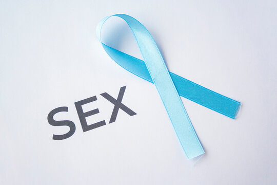 Blue Ribbon As Prostate Cancer Symbol On White Paper With Quote Sex, Quality Of Life With Oncology, Carcinoma.