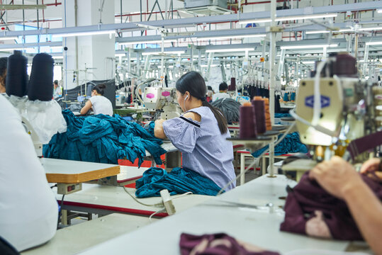 Employee's working with their sewing machines in clothing factory