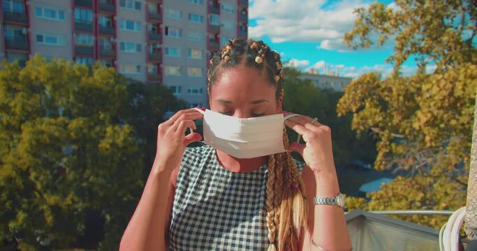 Happy Responsible Mixed Race Female Putting Face Fask in Outdoors During Covid 19 Virus Pandemic Outbreak