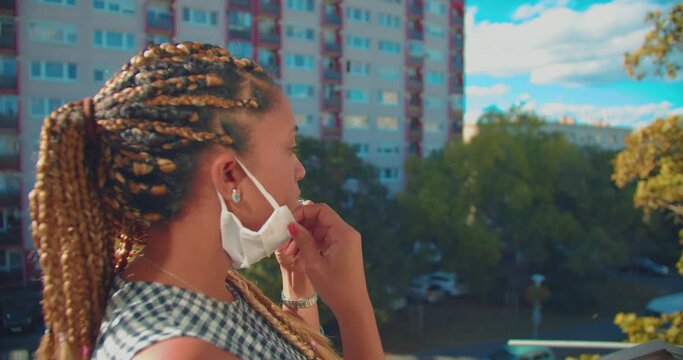 Mixed Race Girl With Braids in Hair and Face Mask During Covid-19 Virus Outbreak and Quarantine Standind Outside