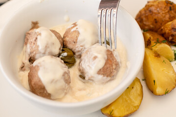 View of Koenigsberger klops,  a specialty traditional german style cooked meat balls in Kaliningrad, Kaliningrad Oblast, Russia, served with mashed potatoes in a white sauce with capers