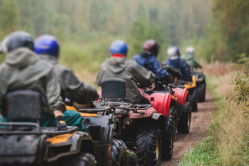 Group of riders riding atv vehicle on off road track, process of driving ATV vehicle, all terrain...