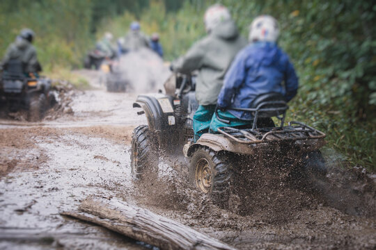 Group Of Riders Riding Atv Vehicle On Off Road Track, Process Of Driving ATV Vehicle, All Terrain Quad Bike Vehicle, During Offroad Competition, Crossing A Puddle Of Mud