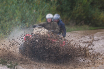 Group of riders riding atv vehicle on off road track, process of driving ATV vehicle, all terrain...