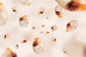 Flying stones calcite mineral on beige. Natural mineral rocks specimen.