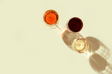 Set of wine in glasses with beautiful shadows. Vintage Hard light. Top view.