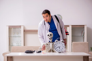 Young male paramedic visiting skeleton patient