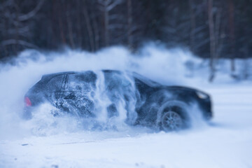 SUV car drifting in snow, during competition, sport car racing drift on snowy race track in winter. © tsuguliev