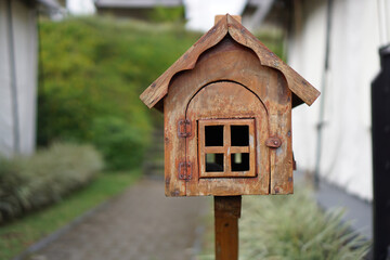 Brown wooden mailbox in the yard              
