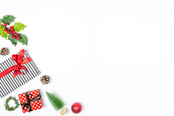 Gift boxes wrapped in striped and dotted black and white and red paper over white background. Christmas presents and ornament preparation. Copy space.