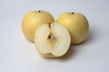 Isolated two rip pears with a pear slice on white background