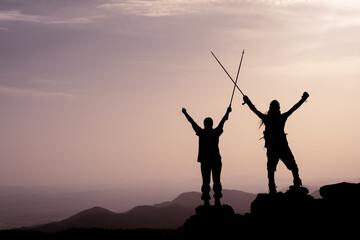 Fototapeta na wymiar Success, achievement and accomplishment concept with hiking people cheering and celebrating of joy with arms raised outstretched up on trekking hike outside. Hikers having fun at sunrise
