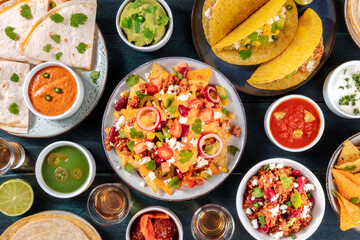 Mexican food. Many various dishes, shot from the top on a dark blue wooden background