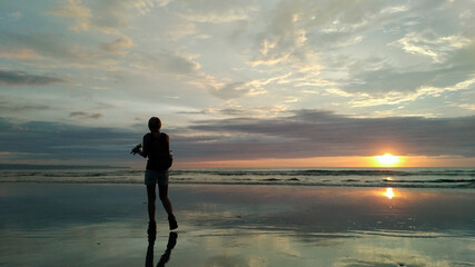 A woman enjoy the beauty of Petitenget Beach Bali Indonesia