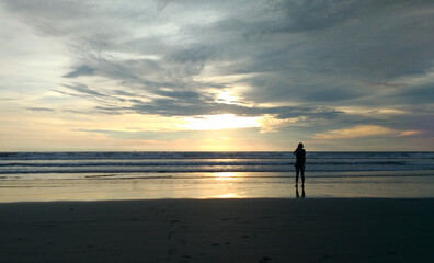 A woman enjoy the beauty of Petitenget Beach Bali Indonesia