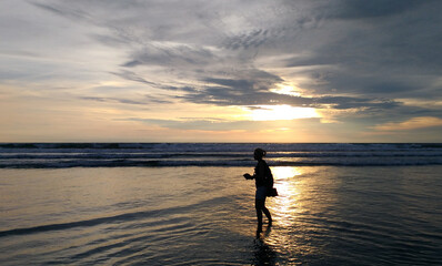 Fototapeta na wymiar A woman enjoy the beauty of Petitenget Beach Bali Indonesia