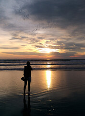 Fototapeta premium A woman enjoy the beauty of Petitenget Beach Bali Indonesia