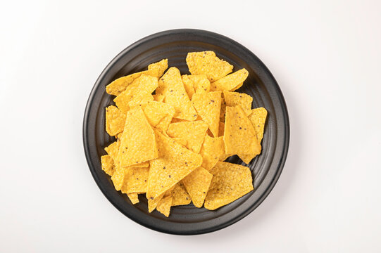 Chip Nachos In Black Plate  Isolated On White Background. Top View
