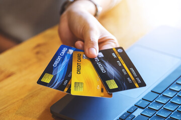 Closeup image of a woman holding and showing credit cards