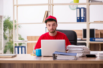 Young man in red cap sitting in the office