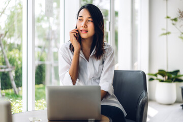 Portrait of smiling happy beautiful asian woman relaxing using digital smartphone.Young asian girl talk with friend at cafe