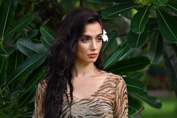 woman in green leaves enjoying nature.