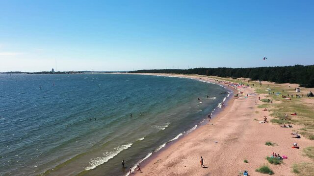 Aerial view of the Tulliniemi beach, people sun bathing and swimming, on a warm, sunny, summer day, in Hanko, Southern Uusimaa, Finland - still, drone shot
