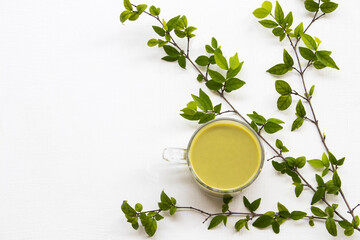 herbal healthy drinks hot green tea ,milks for health care with leaf arrangement flat lay style on...