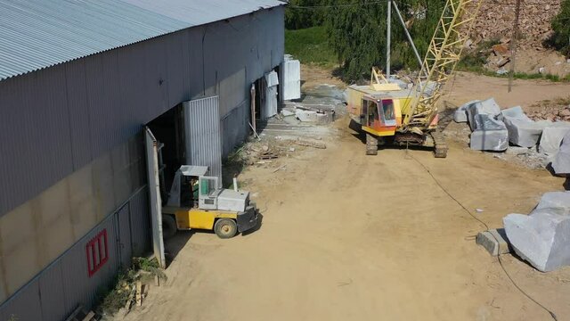 loader drives into the warehouse where the marble is stored