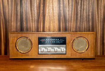 1970s vintage radio isolated with wood panelling backdrop 