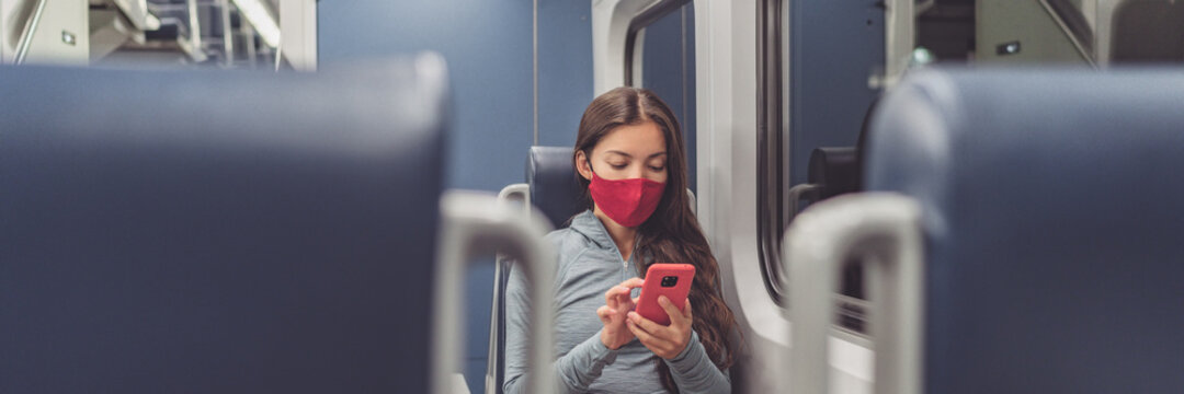 Train passenger using mobile phone during travel commute wearing face mask for coronavirus pandemic. Panoramic banner of people lifestyle commuting after work at night.