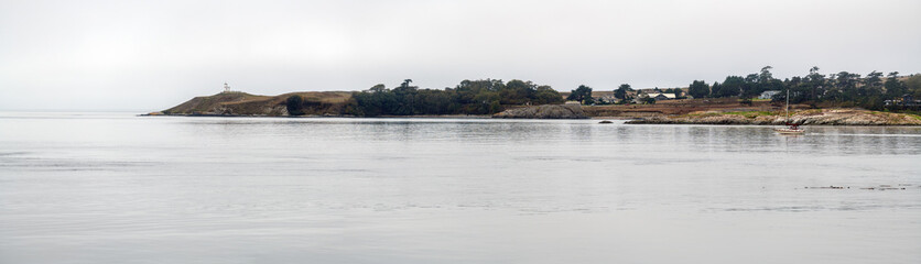 Panoramic view of Cattle Point Lighthouse from Shark Reef Sanctuary, Lopez Island, Washington, USA