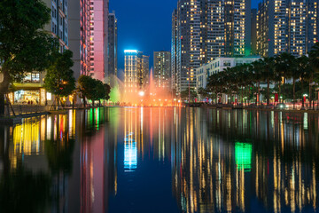 Illuminated building facades with reflection on lake