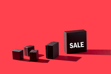 Black boxe with Sale word on red background for Shopping and discount concept.Copy space