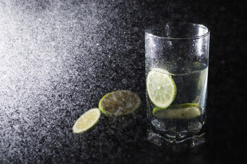 Lime water. Drinking water with fresh lime. Mineral water. Healthy, mineral-rich, refreshing water with lime.