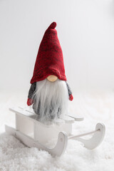 Christmas imp on sleigh with snowy landscape