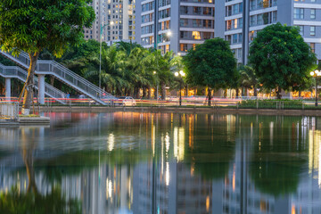 Illuminated building facades with reflection on lake